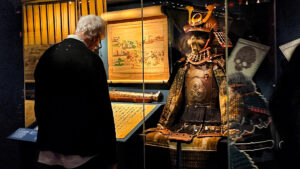 Visitor viewing Kaga province samurai armour at the British Museum exhibition